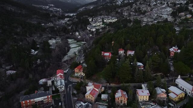 ski resort in winter, Cinematic drone view above a moaintain village coverd by snow