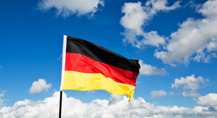 German flag waving against blue sky