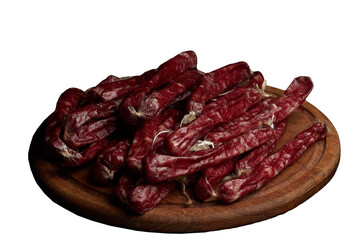 Smoked sausages (cabanos) on a wooden board close-up.