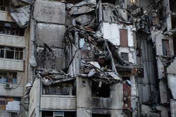 Closeup residential building, a part of civilian infrastructure, bombed by russian army. War in...
