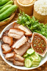 Deep fried pork belly with fish sauce , Fried streaky pork with fish sauce ,thai food , top view food table