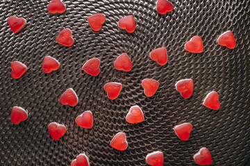 Candies in the form of a red heart on the table. Composition for Valentine's Day February 14th. Valentine Card Holiday concept In Romantic Background.