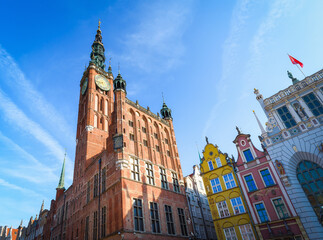 Beautiful architecture of the old town in Gdansk with city hall and Artus court, Poland. A walk through the city on a sunny summer day - obrazy, fototapety, plakaty