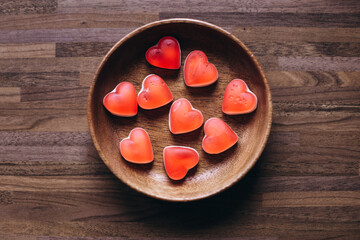 Candies in the form of a red heart on the table. Composition for Valentine's Day February 14th. Valentine Card Holiday concept In Romantic Background.