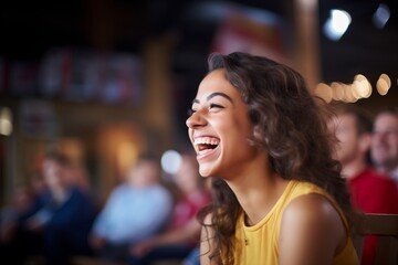 girl laughing at a comedy show on tv - obrazy, fototapety, plakaty