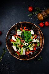 Greek salad of cucumber, tomato, sweet pepper, lettuce, red onion, feta cheese and olives.