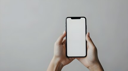 Happy young woman holding mobile smartphone with blank white screen background