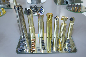 Modern milling cutters, inserts and other parts of milling machines placed on stand