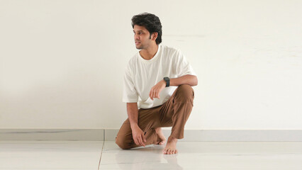 Indian man half sitting in floor