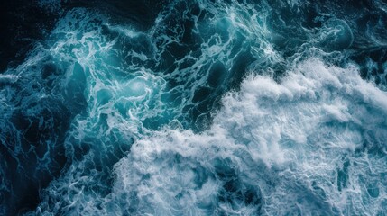 Fototapeta premium Aerial view of deep blue sea with frothy waves