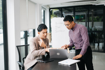 Kind leader executive manager share and discuss business solutions plan ideas on tablet with Asian...