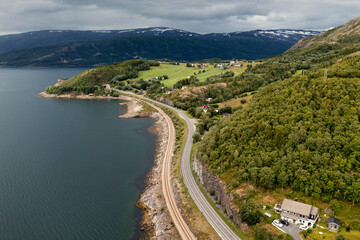 Fototapeta na wymiar Aerial View of a Coastal Road next to a Railway in Northern Norway