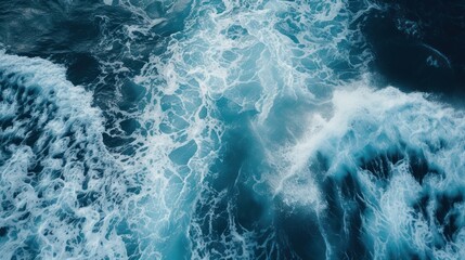 Obraz premium Aerial view of deep blue sea with frothy waves