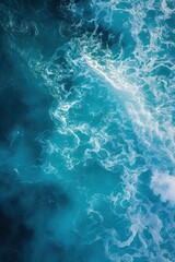 Fototapeta premium Aerial view of deep blue sea with frothy waves