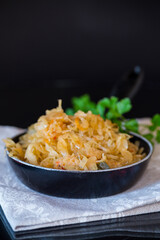 cabbage stewed with spices and carrots in a frying pan , © Peredniankina