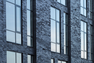 Obraz premium Multi storey black brick building.