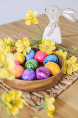 Obraz na płótnie Canvas Easter eggs and table decor top view. easter still life with eggs and tulips, easter eggs and tulips on wooden background