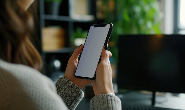 Mockup image of female hands holding smartphone with blank white screen