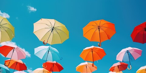 Fototapeta na wymiar Colorful umbrellas floating in the air. Ideal for adding a playful touch to any design project