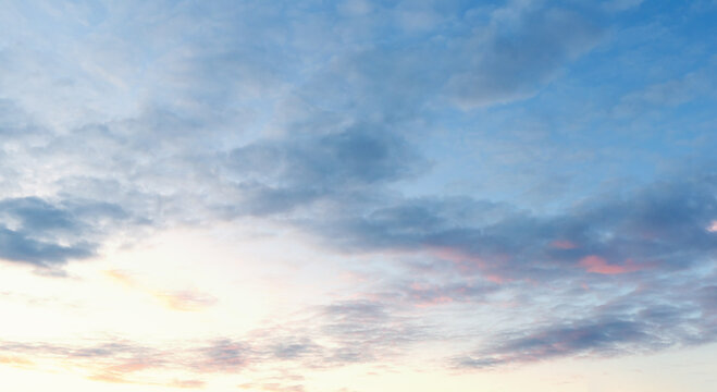 Beautiful sunset sky. Sunset sky panorama with Cirrus clouds. Panorama of the blue-pink sunset sky - the gentle sky on the horizon. Natural sky, amazing and cinematic sunset texture background