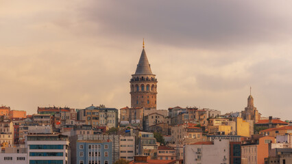 Istanbul, Türkiye: View of the Galata Tower. Istanbul on a summer day with a view of the Galata Tower. Aerial evening shot of the Galata Tower in Istanbul, Turkey. Aerial view of landmark at golden ho