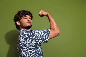 Profile photo of young amazing strength student raised fist up huge biceps and motivation being...