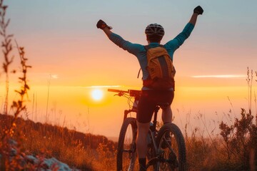 Exhilarated by the freedom of the open sky, a cyclist raises their arms in triumph while riding their bicycle through the grass at sunrise