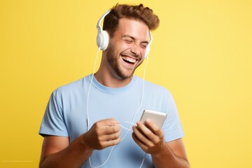 A man wearing headphones and listening to music on his phone. Suitable for lifestyle, technology, and music-related projects