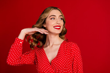 Portrait of classy stunning lady arm touch wavy hairdo look empty space ad isolated on vivid red color background