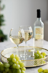 two glasses of white wine on a beautiful tray
