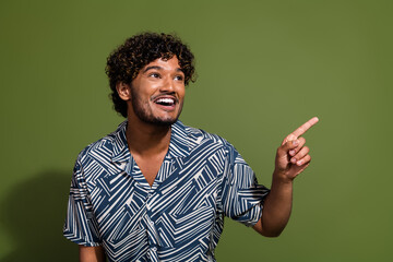 Photo of young latin guy curly hair wearing stylish shirt direct finger look interesting event in...