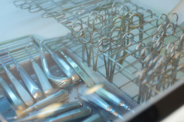 Surgical medical instruments close up in disinfection cabinet, selective focus