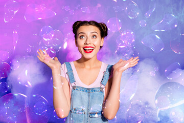 Creative magical collage of girl amazed by visual effect illusion flying water bubbles magic world over purple violet background