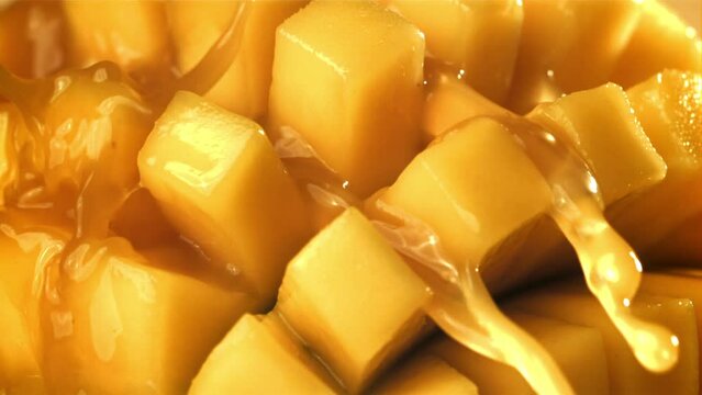 The juice flows through the sliced mango fruit. Filmed on a high-speed camera at 1000 fps. High quality FullHD footage