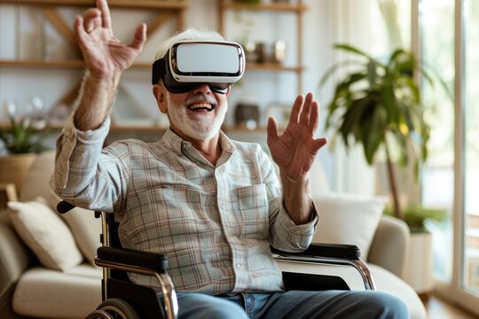 Cheerful disabled senior man in a wheelchair gesturing and smiling while wearing the virtual reality goggles at home in the living room 