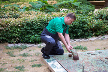 A man is busy repairing a sewer well.