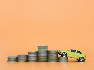 Toy car and stack of coins. The concept of saving money and manage to success transport business