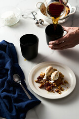 Apple Crumble Pie with vanilla ice cream scoops made from caramelized apples with spices. High-key photo, white marble background. breakfast concept food photo