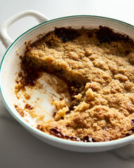 Apple Crumble Pie made from caramelized apples with spices. High-key photo, white marble background. breakfast concept food photo