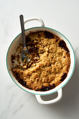 Apple Crumble Pie made from caramelized apples with spices. High-key photo, white marble background. breakfast concept food photo