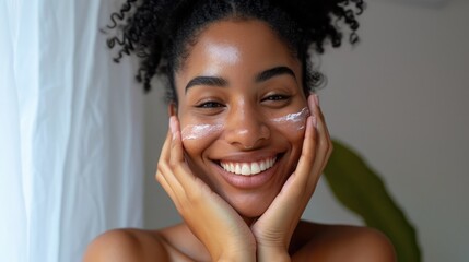 Beautiful black body positive woman touching her face and smiling at camera, making beauty treatments at home. Young african american lady enjoying selfcare