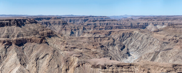 multiple escarpment slopes and meandering dry riverbed looking south from Sunset viewpoint, Fish River Canyon,  Namibia