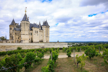 Fototapeta na wymiar Castle Saumur, France, located at the Loire river under a beautiful sunny cloudscape during daytime.