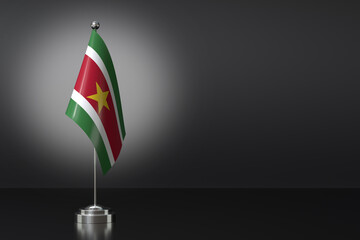 Fototapeta premium Small Republic of Suriname Flag in Front of Black Background, 3d Rendering