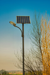 Lamppost powered by solar energy  under a blue sky