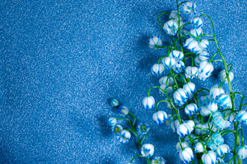 Bouquet lilies of valley The flower painted blue shimmering silver background Mother's Day greeting...