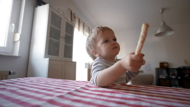 Witness the enchanting moment as a little boy captivates the world with his bread-holding mastery, revealing the potential of a single slice.