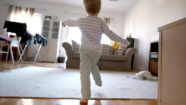 In this captivating video, a curious little boy explores the wonders of his living room, discovering magic in every corner.