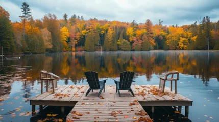 Foto op Canvas Wooden dock with chairs on calm fall lake © Shani work