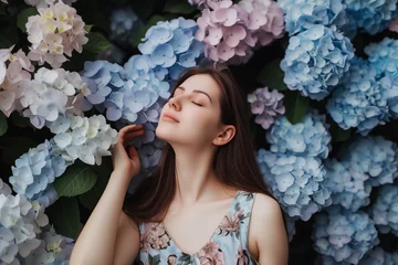 Tuinposter woman in a summer dress against a backdrop of hydrangeas © Alfazet Chronicles